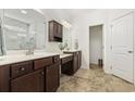 Elegant bathroom featuring dual vanities, dark wood cabinetry, and a tile floor at 129 Yeomans Dr., Conway, SC 29526