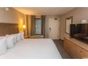 King size bed, dresser, TV, and balcony access in condo bedroom at 1501 S Ocean Blvd. # 1542, Myrtle Beach, SC 29577
