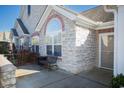 Small patio with stone wall, wrought iron bench, and exterior door at 160 Stonegate Blvd. # 160, Murrells Inlet, SC 29576