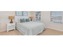 Cozy bedroom with a queen-size bed, nightstand, and window with blinds at 201 Jeff Waters Circle, Longs, SC 29568