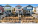 Three beach houses with oceanfront walkway access at 2022 N Waccamaw Dr., Garden City Beach, SC 29576