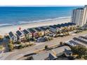 Aerial view showcasing colorful beach homes, oceanfront location, and proximity to the beach at 2022 N Waccamaw Dr., Garden City Beach, SC 29576