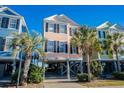 Beach house with light peach exterior and ocean view at 2022 N Waccamaw Dr., Garden City Beach, SC 29576