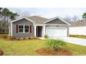 Gray house with red shutters, a white garage, and a well-manicured lawn at 207 Jeff Waters Circle, Longs, SC 29568