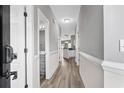 Bright hallway with laminate wood floors and access to bedrooms and bathrooms at 209 Wando River Rd. # 10C, Myrtle Beach, SC 29579