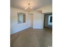 Bright dining area with chandelier and mirrored wall at 2276 Essex Dr. # K, Surfside Beach, SC 29575