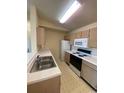 Galley kitchen with white cabinets and appliances at 2276 Essex Dr. # K, Surfside Beach, SC 29575