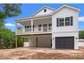 Charming two-story home with a spacious porch and a convenient ground-level garage at 2428 Park St., North Myrtle Beach, SC 29582