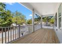 Inviting covered porch with wood floors and classic white railings offering a relaxing outdoor space at 2428 Park St., North Myrtle Beach, SC 29582