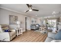 Inviting living room featuring a ceiling fan, stylish furniture, and wood-look flooring at 301 43Rd Ave. N, North Myrtle Beach, SC 29582