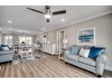 Bright living room with hardwood floors, neutral walls, and beach-themed decor at 301 43Rd Ave. N, North Myrtle Beach, SC 29582