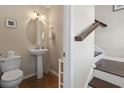 Small bathroom with pedestal sink, toilet and staircase view at 327 Simplicity Dr., Murrells Inlet, SC 29576