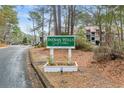 Indian Wells Golf Villas community sign on a private road surrounded by mature trees and landscaping at 401 Indian Wells Ct. # 401, Murrells Inlet, SC 29576