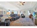 Spacious living room with reclining sofas, large TV, and hardwood floors at 409 Stevia Ct., Conway, SC 29526