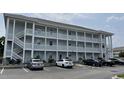 Exterior of light blue building with stairs and parking at 4679 Wild Iris Dr. # 101, Myrtle Beach, SC 29577