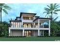 Rear elevation of a luxurious home with multiple stories and covered balconies, set against lush landscaping and palm trees at 4702 N Ocean Blvd., Myrtle Beach, SC 29577