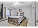 Bedroom with a double bed, window, and ceiling fan at 4870 Dahlia Ct. # 19-103, Myrtle Beach, SC 29577