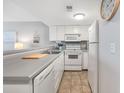 Well-equipped kitchen featuring white cabinets and appliances at 5905 South Kings Hwy. # 5105-D, Myrtle Beach, SC 29575