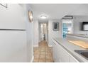 White kitchen cabinets, gray countertops, and tiled floors at 5905 South Kings Hwy. # 5105-D, Myrtle Beach, SC 29575