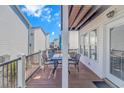 Deck with table and chairs, offering a relaxing space at 6001-1028 S Kings Hwy., Myrtle Beach, SC 29575