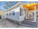 Side view of a charming beach cottage with gray steps and stone base at 6001-Z34 S Kings Hwy., Myrtle Beach, SC 29575