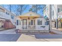 Cute beach cottage with a yellow awning and white picket fence at 6001-Z34 S Kings Hwy., Myrtle Beach, SC 29575