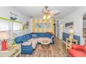 Bright living room with blue sectional sofa and beach decor at 6001-Z34 S Kings Hwy., Myrtle Beach, SC 29575