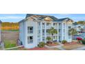 Beautiful condominium with verdant landscaping, and lovely balconies and nice exterior finishes at 661 Tupelo Ln. # 16B, Longs, SC 29568