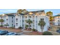 Attractive condo building boasting spacious balconies, manicured lawns, and inviting curb appeal at 661 Tupelo Ln. # 16B, Longs, SC 29568