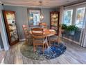 Charming dining room with a round wood table, display cabinets, and bright window, creating a welcoming atmosphere at 706 33Rd Ave. S, North Myrtle Beach, SC 29582