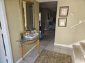 Bright entryway with glass-top table, mirror, and view to living room at 800 Egret Circle # 45, Little River, SC 29566
