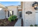 Inviting front entryway with a decorative wreath, attractive brickwork, and well-maintained landscaping at 902 Villarosa Dr., Myrtle Beach, SC 29572