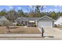 Single story house with a two-car garage and manicured lawn at 1460 Abberbury Dr., Conway, SC 29527
