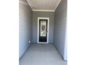 Covered front porch features stylish door and accent paneling at 1519 Wood Stork Dr., Conway, SC 29526
