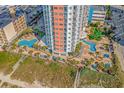 Elevated view of resort pools and surrounding loungers at 1605 S Ocean Blvd. # 810, Myrtle Beach, SC 29577