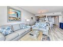 Bright living room with comfy sofas and ocean view at 1990 N Waccamaw Dr. # 1109, Garden City Beach, SC 29576