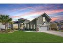 Charming home featuring lush green lawn, manicured landscaping, and a two-car garage at 2004 Via Palma Dr., North Myrtle Beach, SC 29582