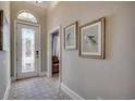 Welcoming foyer with decorative glass door, light-colored walls, and stylish rug at 2004 Via Palma Dr., North Myrtle Beach, SC 29582