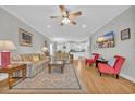 Spacious living room with hardwood floors, a sofa, and two armchairs at 2009 Hillside Dr. S, North Myrtle Beach, SC 29582