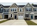 New townhomes featuring an attached one car garage and a concrete driveway with a dark roof at 2065 Nw Parow Ln Nw # D, Calabash, NC 28467