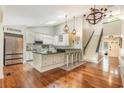 Spacious kitchen with white cabinets, granite island, and hardwood floors at 245 Windover Dr., Pawleys Island, SC 29585