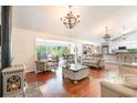 Open living room with hardwood floors, comfortable seating, and a wood-burning stove at 245 Windover Dr., Pawleys Island, SC 29585