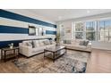 Spacious living room with white sofas and blue accent wall at 2557 Pete Dye Dr. # 903, North Myrtle Beach, SC 29582