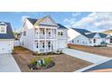 Two-story house with gray siding, white trim, and a two-car garage at 299 Empyrean Circle, Myrtle Beach, SC 29588