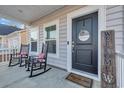 Front porch with rocking chairs and a welcoming sign at 299 Empyrean Circle, Myrtle Beach, SC 29588