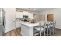 Modern kitchen with white cabinets, island, and stainless steel appliances at 384 Clear Lake Dr., Conway, SC 29526