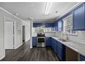Modern kitchen with blue cabinets and granite countertops at 4239 Villas Dr. # 609, Little River, SC 29566