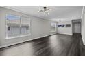 Spacious living room with hardwood floors and large windows at 4239 Villas Dr. # 609, Little River, SC 29566