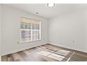 Bright bedroom with large window and wood-look floors at 4251 Villas Dr. # 303, Little River, SC 29566