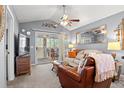 Spacious living room with leather chairs, sofa, and access to a balcony at 4416 Eastport Blvd. # N15, Little River, SC 29566